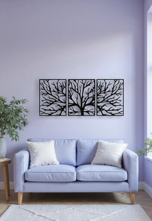 Size comparison of black tree wall art panels in a minimal room, showing medium size at 26x18 inches and large size at 32x22 inches, displayed side by side on a white wall