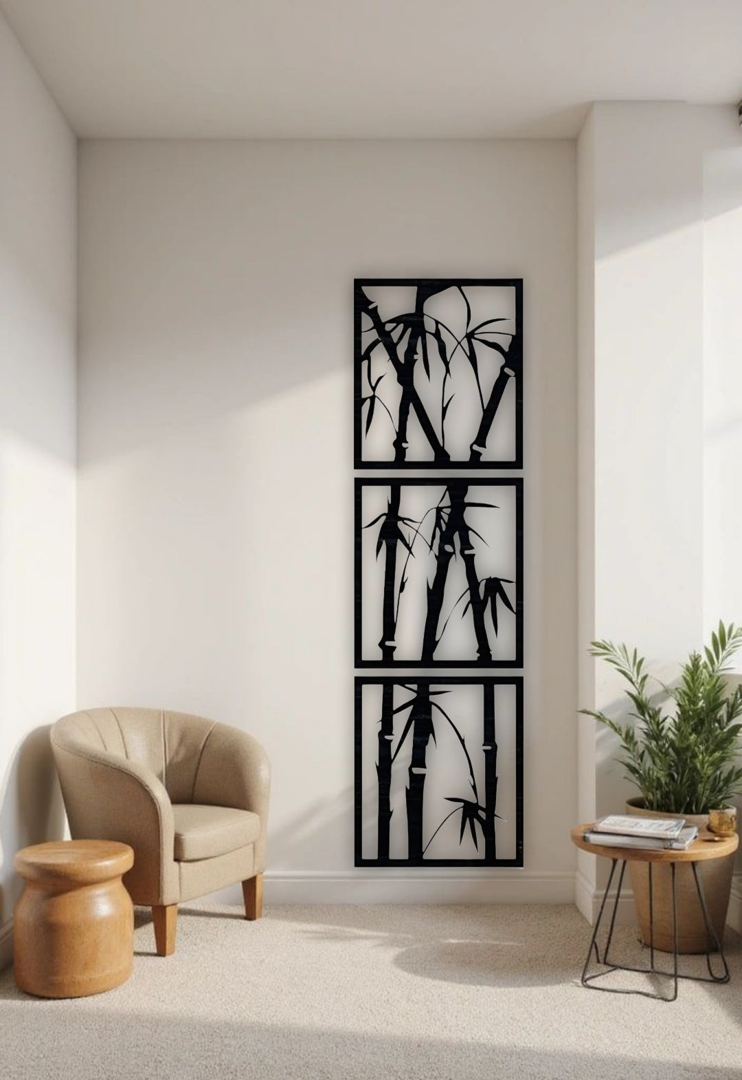 Vertical 3-piece wooden bamboo wall art panels in matte black, mounted on a white wall in a modern reading nook with beige armchair and green indoor plant.