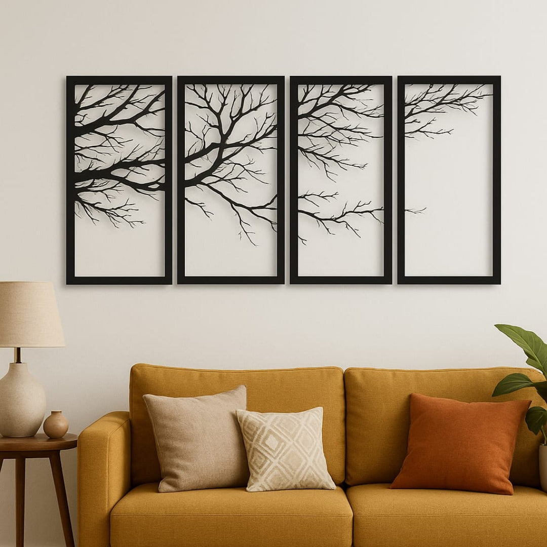 Four framed black and white branch artworks above a mustard yellow sofa with decorative pillows.