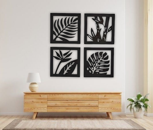 Four-piece square wooden wall art set with tropical leaf and plant designs in black finish, mounted above a modern wooden sideboard