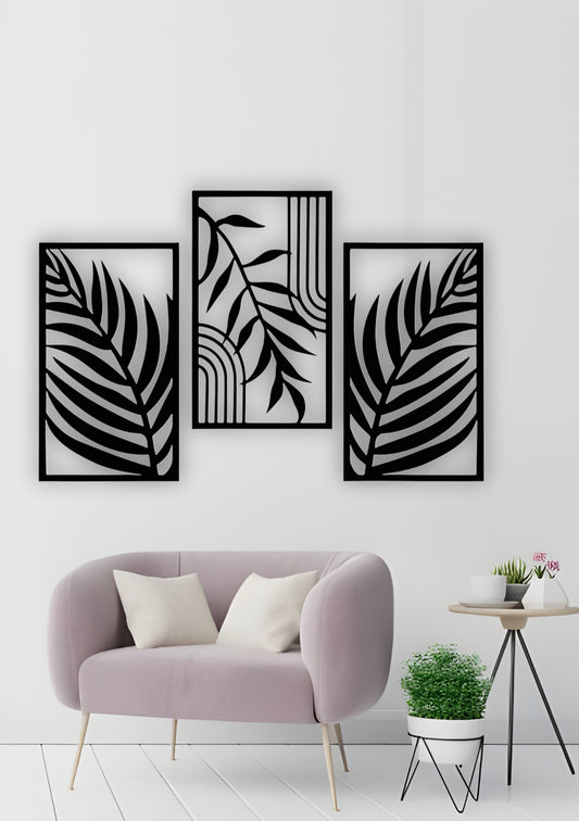 Modern 3-piece black wooden wall art featuring tropical palm leaf patterns, displayed above a light blue sofa in a minimalist grey living room