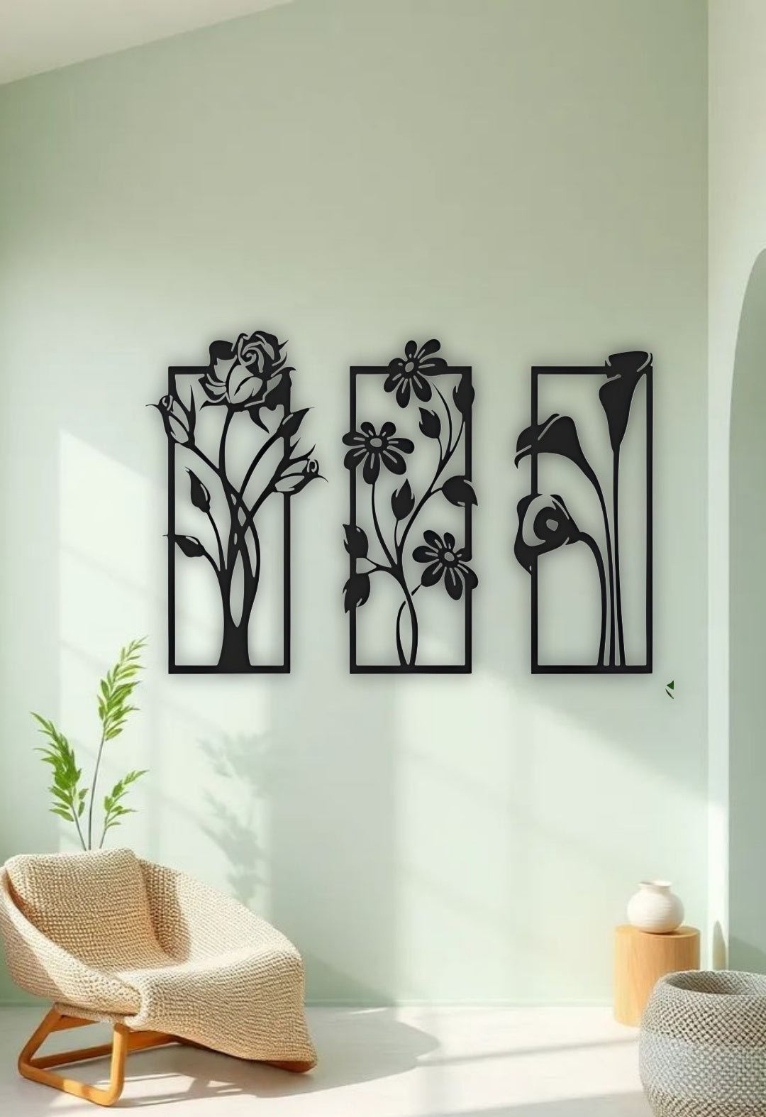 Modern floral-themed wooden wall art set in black finish with three nature-inspired panels mounted in a living space