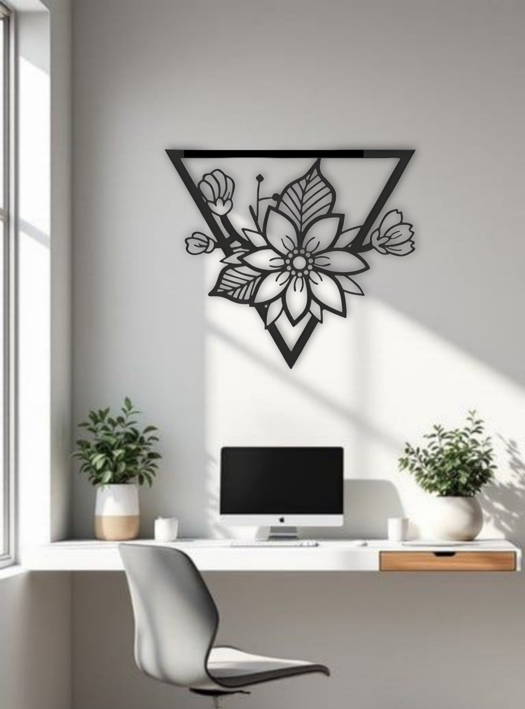 Triangle-shaped floral wooden wall art in black, displayed above a modern white office desk setup
