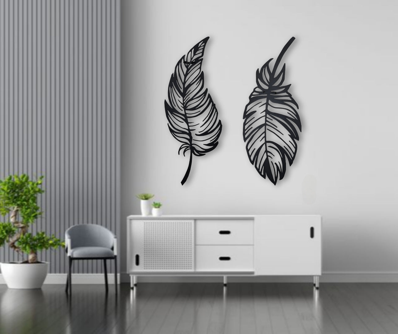 Stylish dual-feather wall art in matte black finish mounted on a blue paneled wall above a tufted sofa.