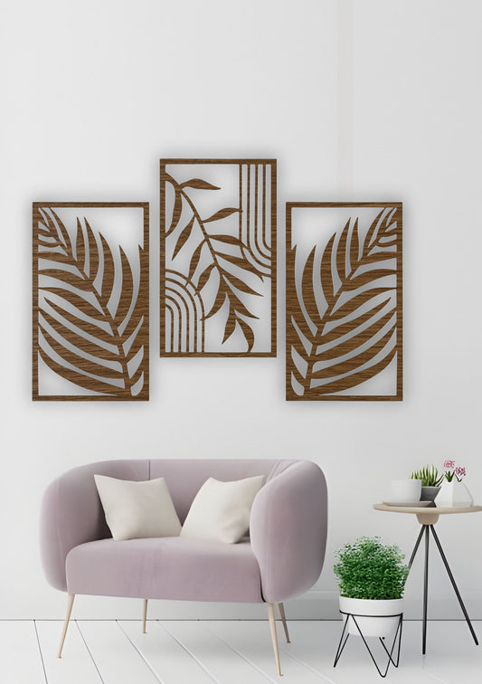 Set of three wood brown wall panels with abstract tropical leaves, mounted in a cozy, modern living room with warm neutral tones