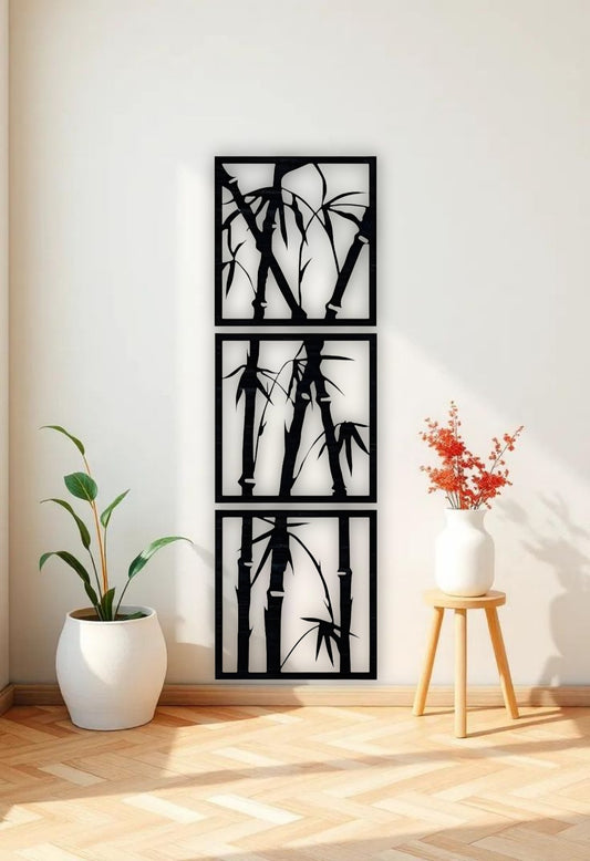 Vertical 3-piece wooden bamboo wall art panels in matte black, mounted on a white wall in a modern reading nook with beige armchair and green indoor plant.