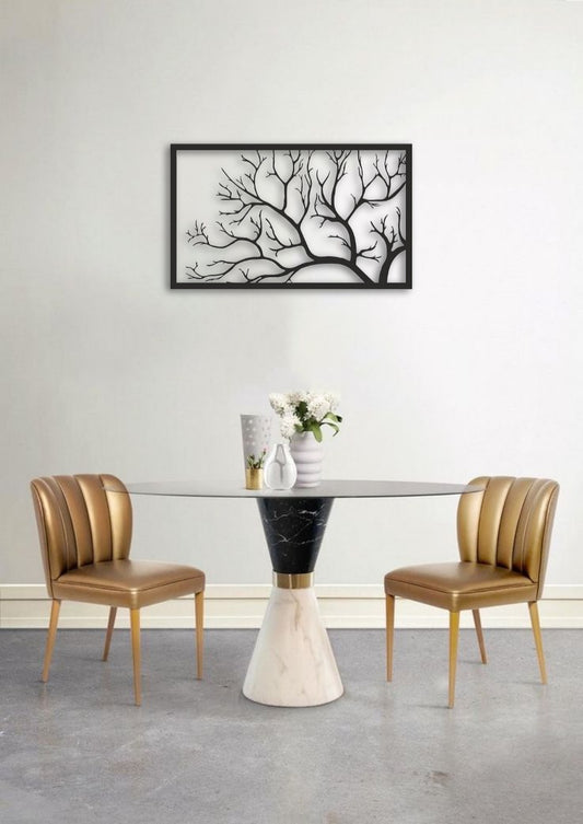 Dining room with a modern table and chairs, featuring a decorative wall art piece.