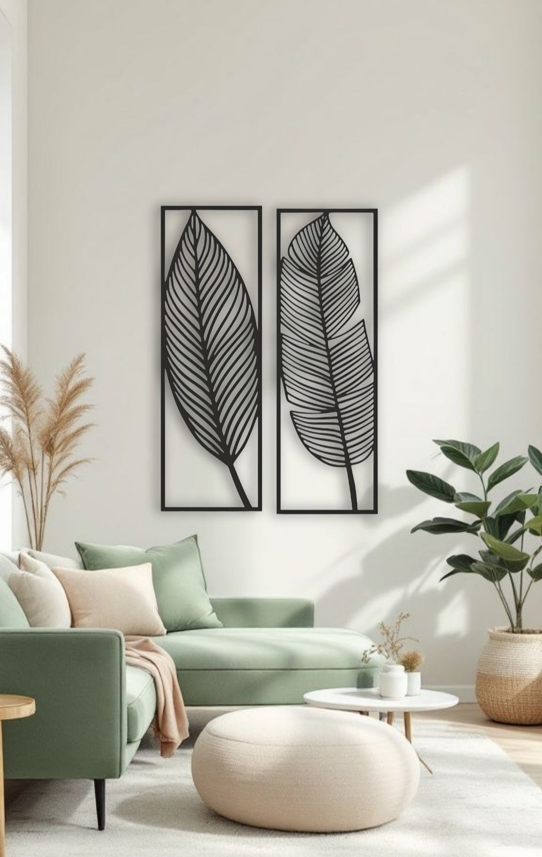 Two tall black wooden wall art panels with leaf designs, each 30 x 10 inches, mounted vertically above a sage green sectional in a modern living room