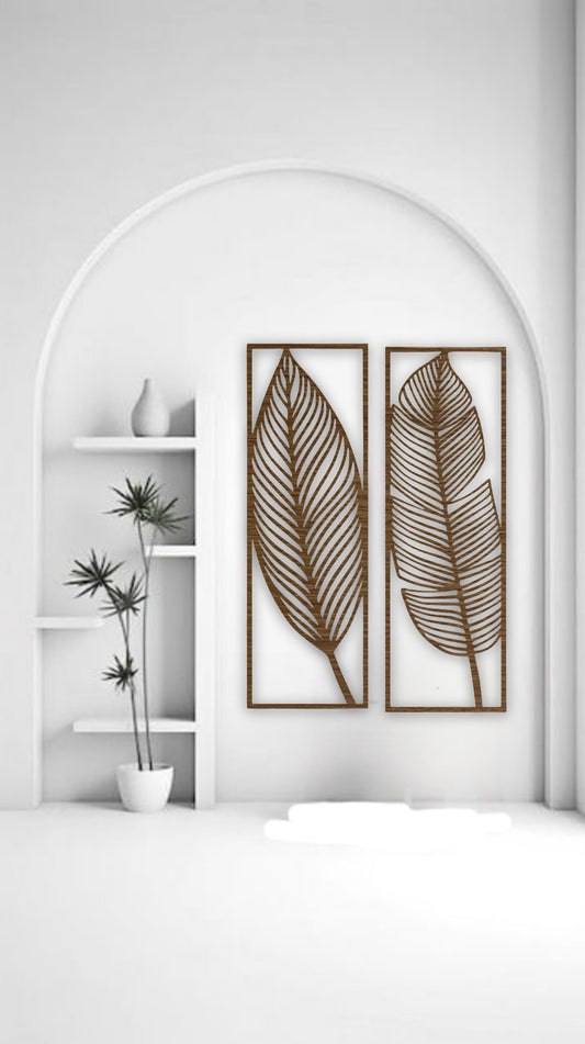Two tall brown wooden wall art panels with leaf designs, each 30 x 10 inches, mounted vertically above a sage green sectional in a modern living room