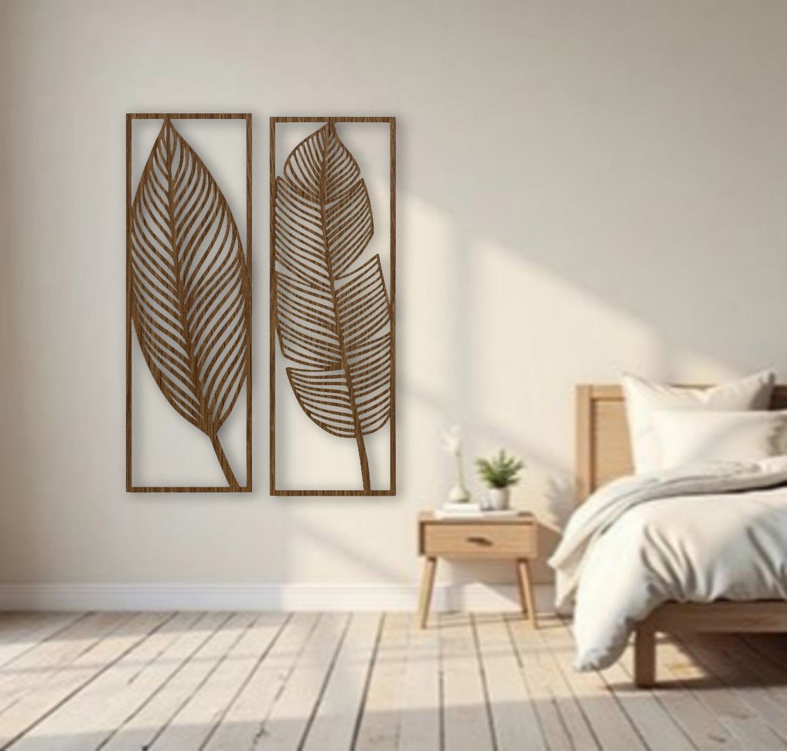 Two tall brown wooden wall art panels with leaf designs, each 30 x 10 inches, mounted vertically above a sage green sectional in a modern living room