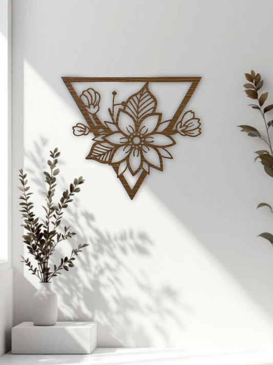 Triangle-shaped floral wooden wall art in natural wood brown finish, styled in a minimal office or workspace interior.