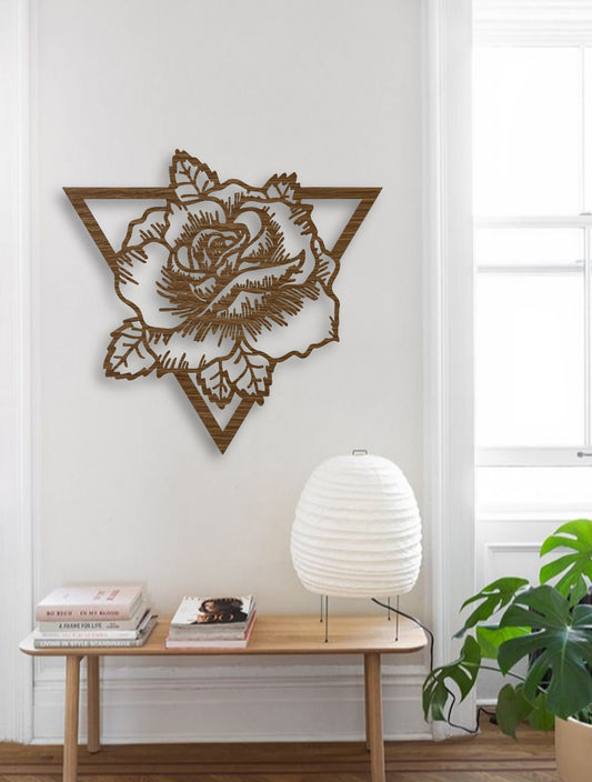 Geometric rose wall art in natural wood brown finish, mounted on a teal wall with decorative table accents in a modern interior.