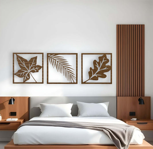 Nature-themed wooden wall art in wood brown finish with three distinct leaf patterns displayed above a bed in a stylish modern room