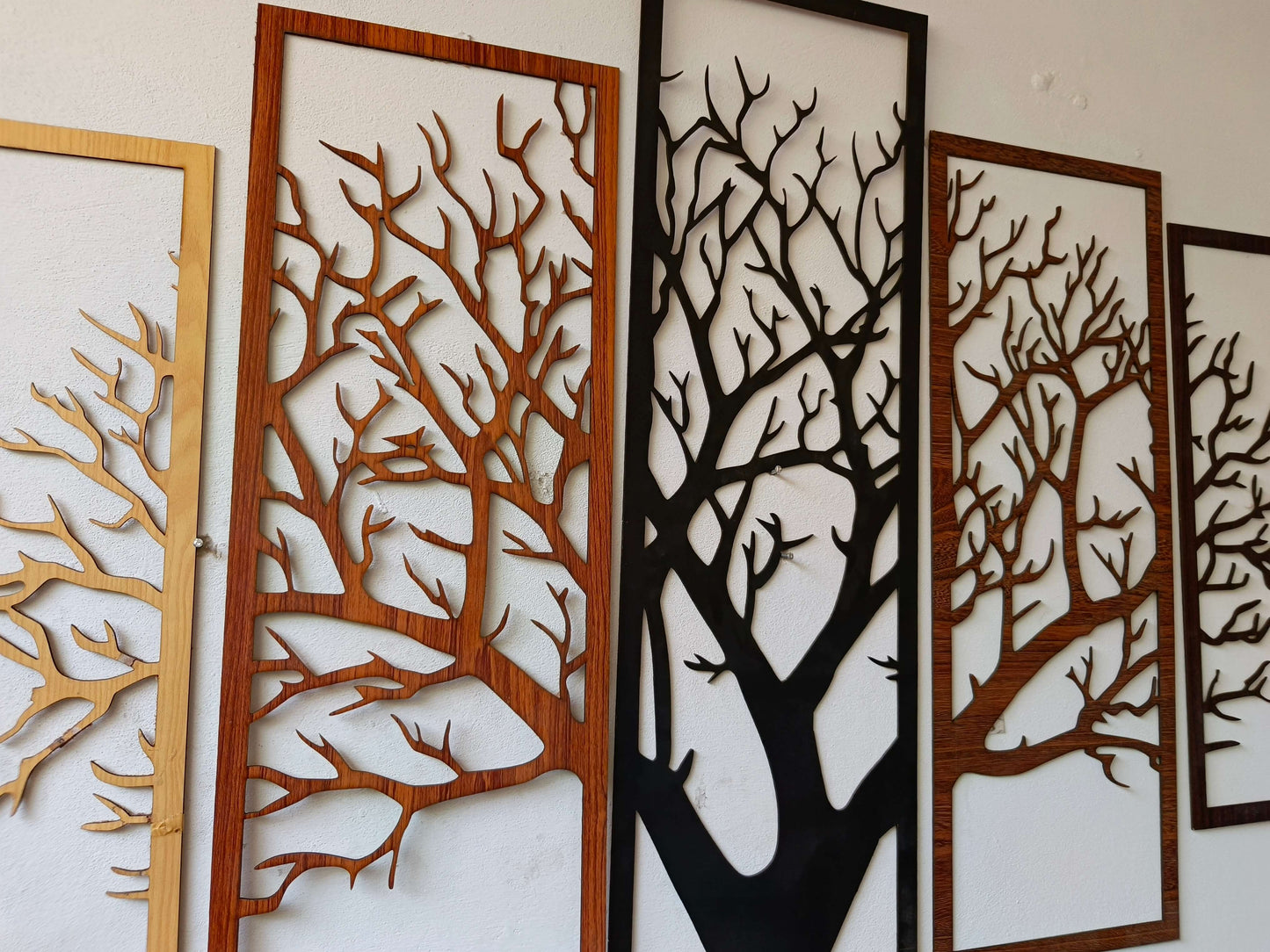 Decorative wall panels with tree designs on a white background