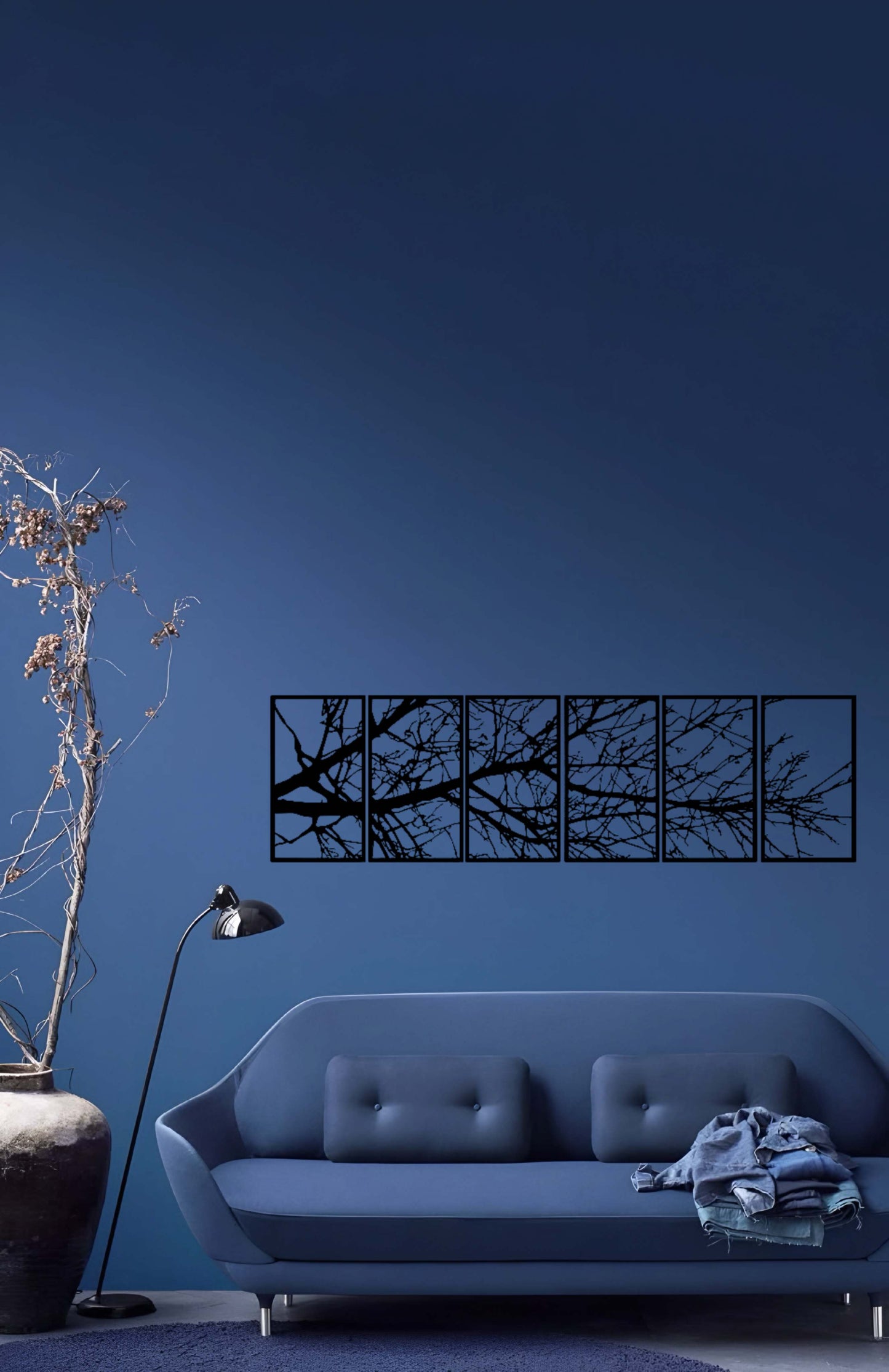 6-panel laser cut wooden wall art featuring abstract tree branches above a modern beige sofa"