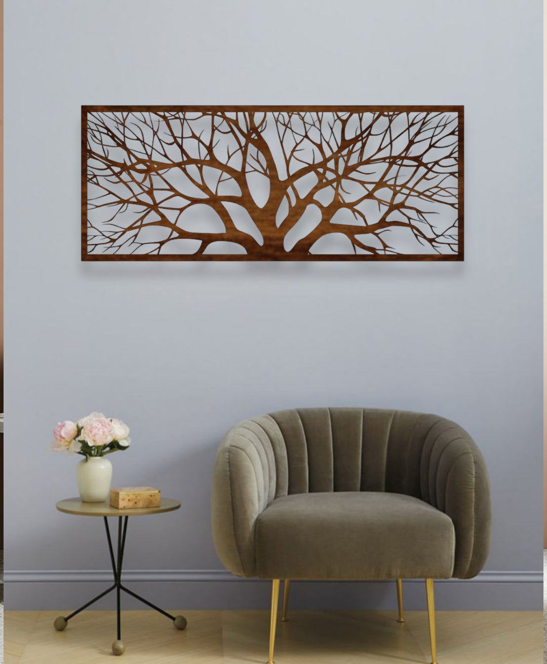 Decorative wall art with tree design above a modern armchair and side table.