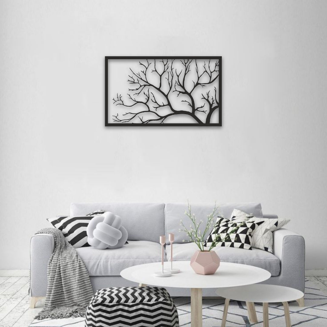 Living room with a gray sofa, decorative pillows, a coffee table, and a framed black and white artwork on the wall.