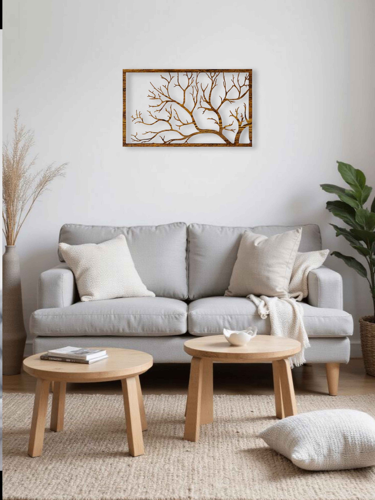 Living room with a gray sofa, wooden coffee tables, and decorative elements.