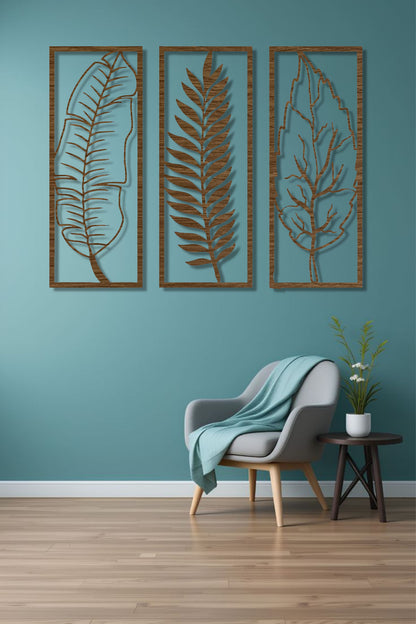 Natural wood brown 3-piece vertical leaf wall art set with botanical designs, displayed in a neutral-toned room beside indoor plants.