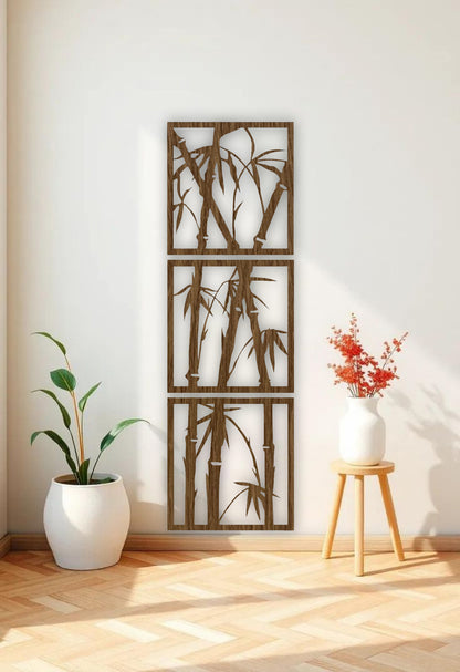Vertical 3-piece wooden bamboo wall art panels in matte black, mounted on a white wall in a modern reading nook with beige armchair and green indoor plant.