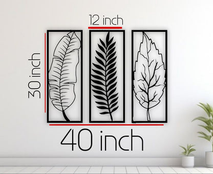 Three leaf-shaped wall art pieces with measurements on a white wall.