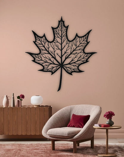 Maple leaf wooden wall art in black color mounted on living room wall