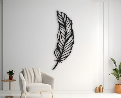 Modern black feather wooden wall art mounted on white wall in minimalist room with chair and hanging pendant lights