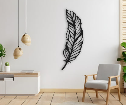 Modern black feather wooden wall art mounted on white wall in minimalist room with chair and hanging pendant lights