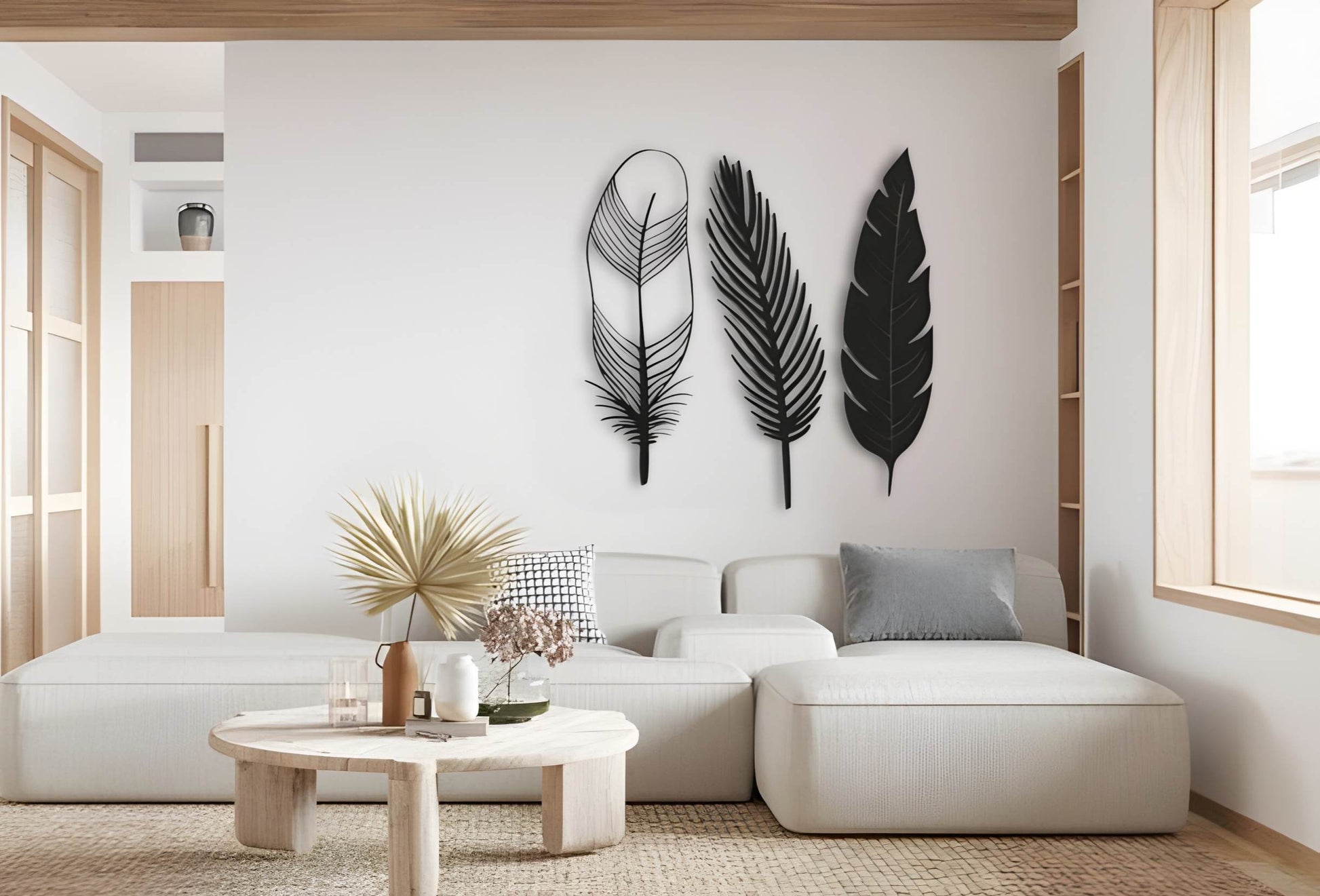 Three-piece modern feather wall art in black color displayed on a clean white wall, offering a stylish and minimalist decorative accent.