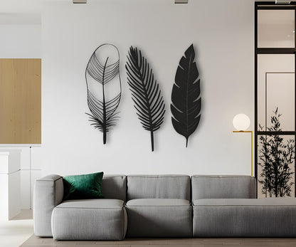 Three-piece modern feather wall art in black color displayed on a clean white wall, offering a stylish and minimalist decorative accent.