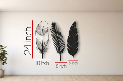 Three-piece modern feather wall art in black color displayed on a clean white wall, offering a stylish and minimalist decorative accent.