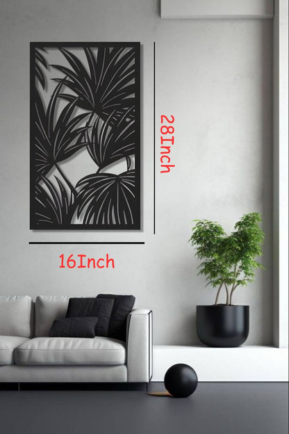 Black tropical leaf wooden wall art panel, 16x28 inches, displayed above a modern cabinet in a minimalist white room with indoor plants and soft lighting