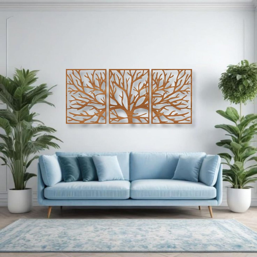 Three-piece wall art featuring a tree silhouette in wood brown finish, mounted above a light blue sofa, surrounded by indoor plants in a modern living room