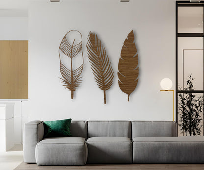 Set of three wooden feather wall decorations in natural brown finish, bringing warmth and rustic charm to a neutral interior backdrop.
