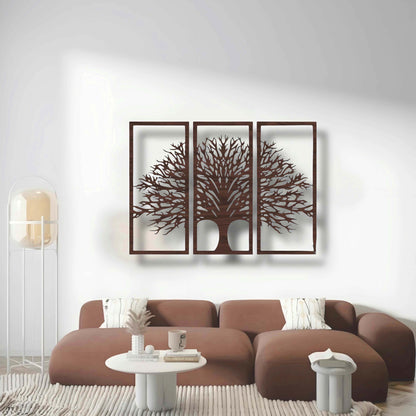 Three-piece black wooden Tree of Life wall art set mounted above a beige modern sofa, surrounded by indoor plants and minimalist decor.