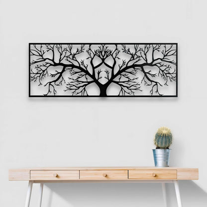 Framed black and white tree art above a wooden console table with a cactus.